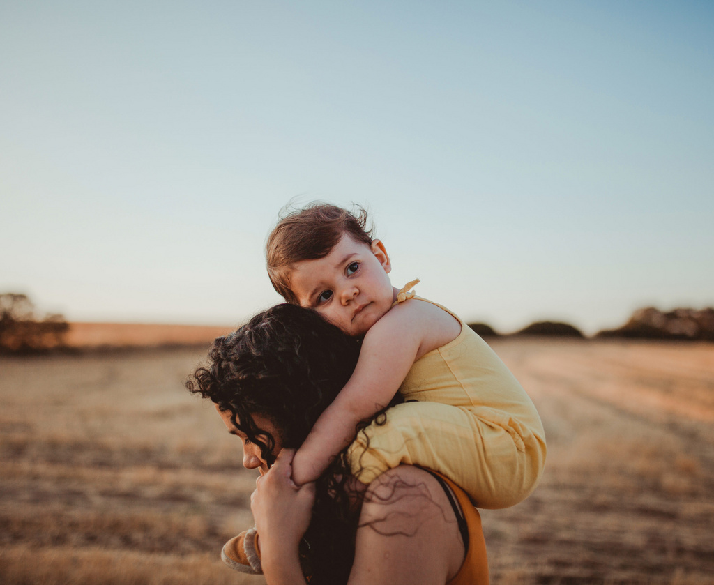 sad baby on moms shoulders